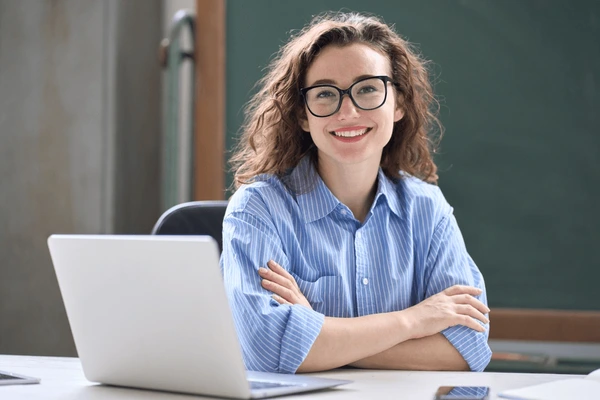 young happy business woman sitting 600nw 2223351415